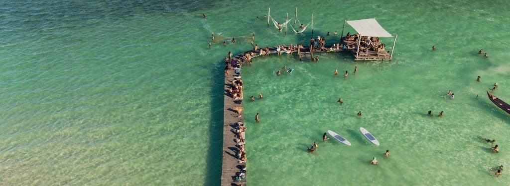 Guests swimming from the wooden dock